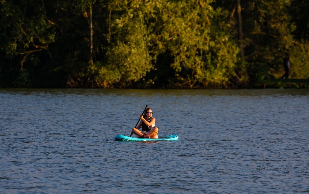 Woman paddleboarding on Lake Murray near Chapin, SC, enjoying outdoor recreation and lakefront living.