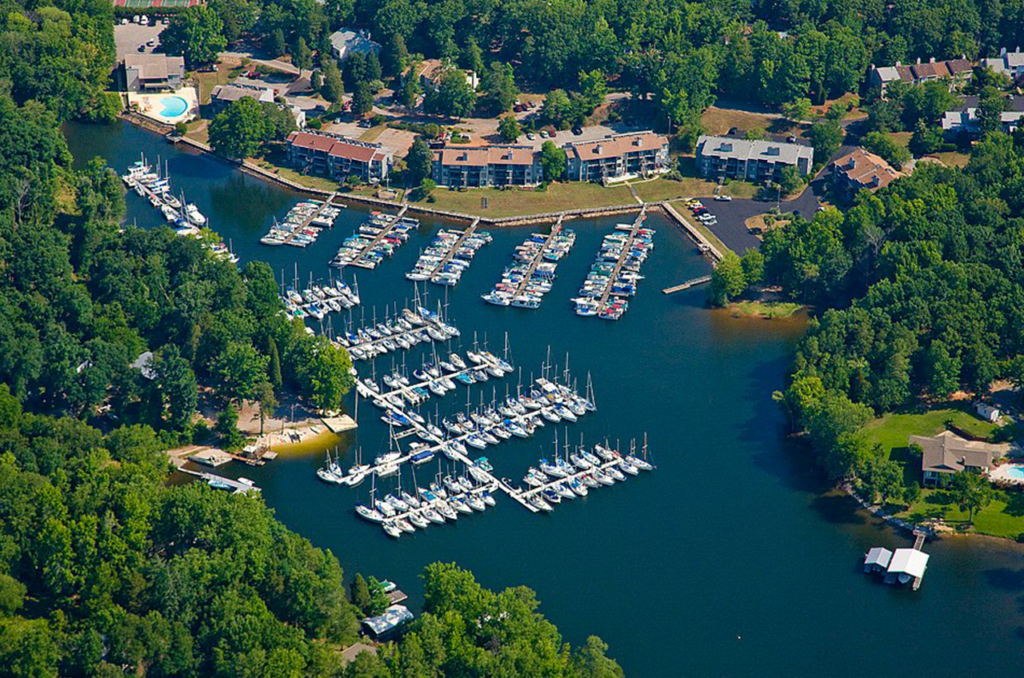 Aerial view of Lake Murray near Irmo, SC, featuring a marina with sailboats, waterfront homes, and lush green surroundings.